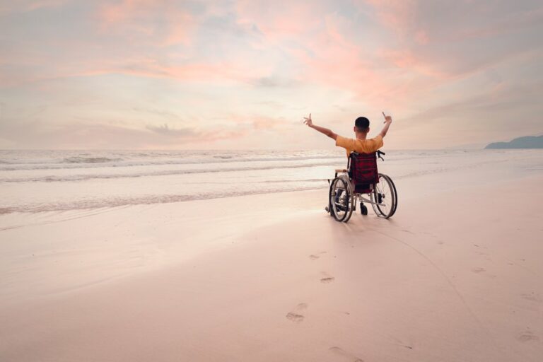 Asian disabled child on wheelchair is fun with activity on the beach in family holiday travel and learning about nature around the sea beach