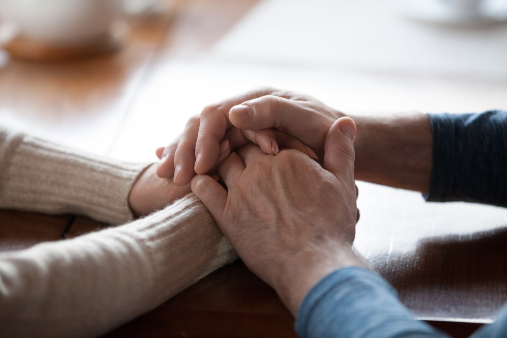 Two people holding hands